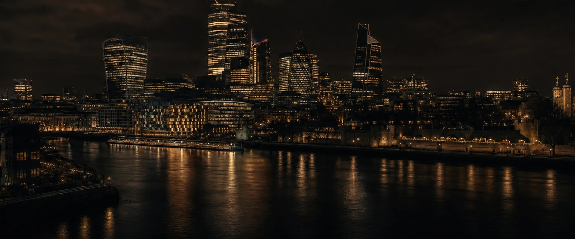 Cinematic dark view of central London at night with the Thames and skyline.